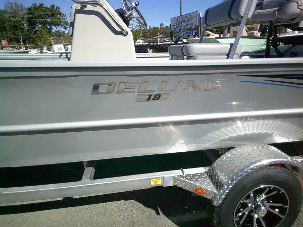 Slide: The Image of 2025 G3 18CCTDLX boat with "Deluxe 18" branding on the side. - 5
