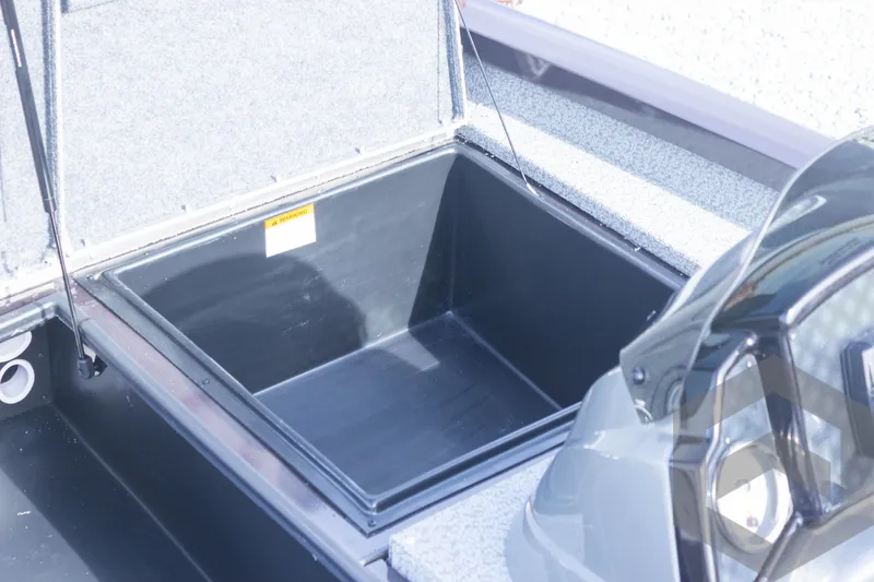 Slide: The Image of 2025 G3 Sportsman 1710 boat storage compartment, open and empty. - 22