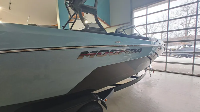 Slide: The Image of 2025 Moomba Max boat in showroom, side view with logo visible. - 14