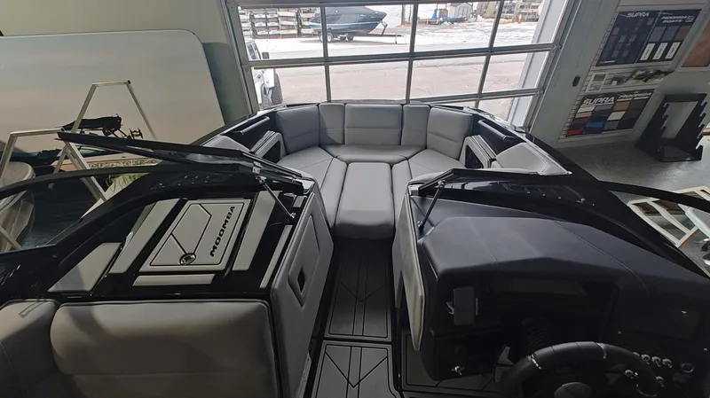 Slide: The Image of 2025 Moomba Max boat interior with sleek seating and modern design in showroom. - 19