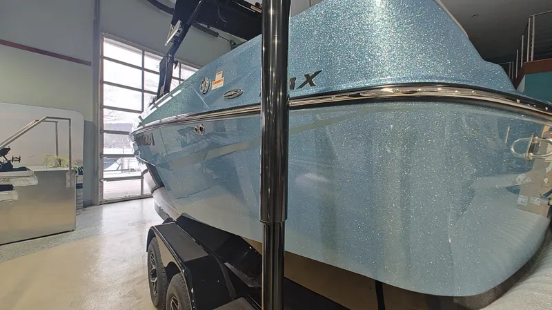 Slide: The Image of 2025 Moomba Max boat with sparkling blue finish in showroom. - 3