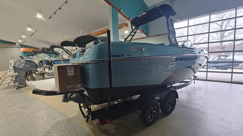 Slide: The Image of 2025 Moomba Max boat displayed in a showroom with other boats. - 5