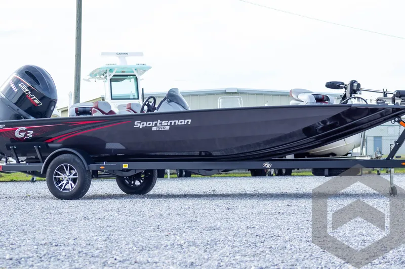 Slide: The Image of 2025 G3 Sportsman 1910 boat on trailer, sleek black design, parked outdoors. - 10