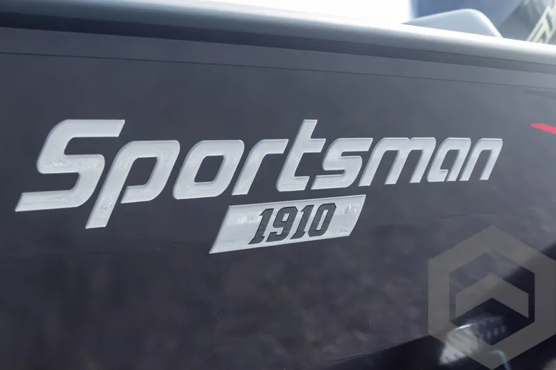 Slide: The Image of Close-up of 2025 G3 Sportsman 1910 logo on a sleek black surface. - 13