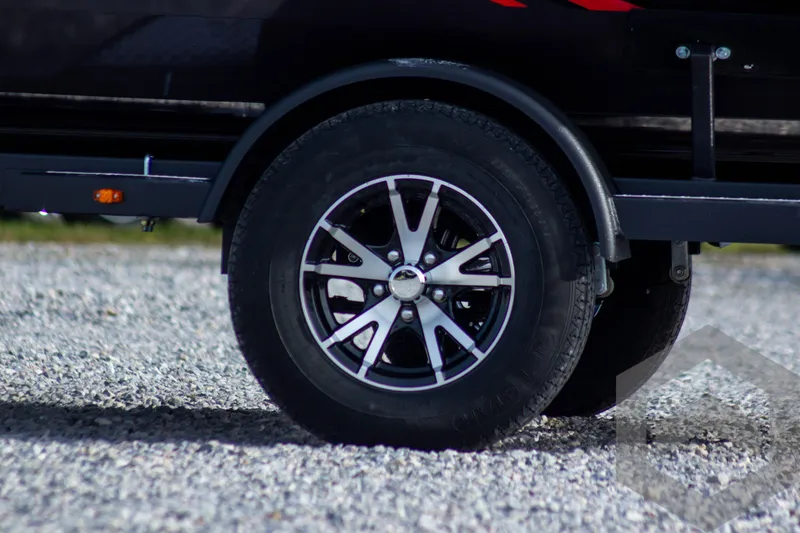 Slide: The Image of 2025 G3 Sportsman 1910 trailer wheel on gravel surface. - 3