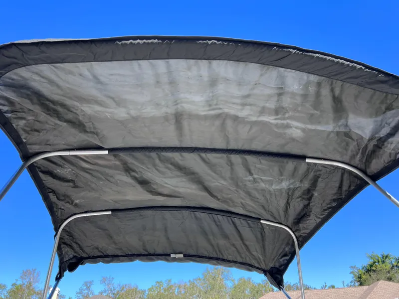 Slide: The Image of Black boat canopy on a 2021 Glasstream 180 CC under clear blue sky. - 32