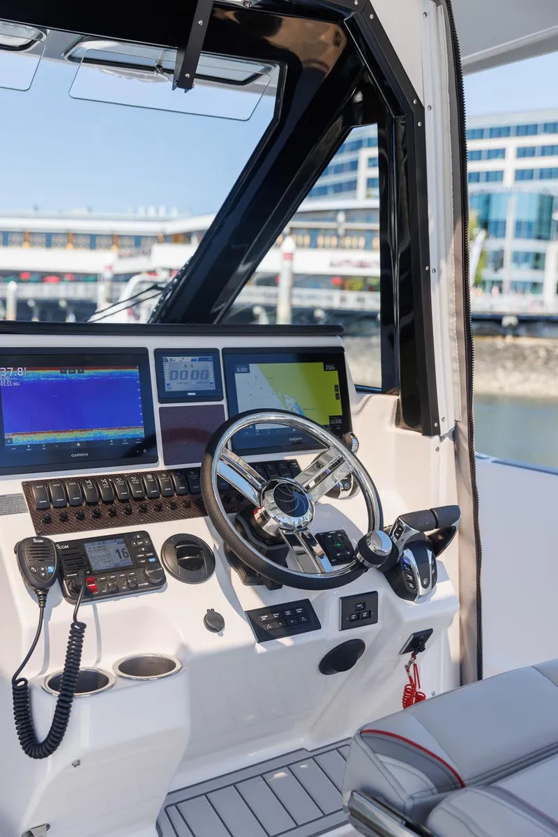 Slide: The Image of 2025 Solara S-310 CW boat cockpit with advanced navigation systems and steering wheel. - 15