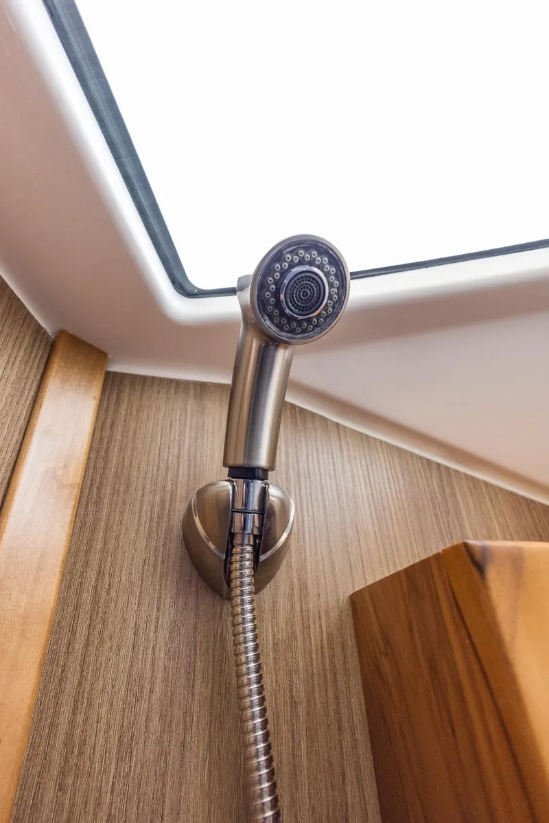 Slide: The Image of Showerhead in Solara S-310 CW yacht, 2025 model, with wood paneling. - 25
