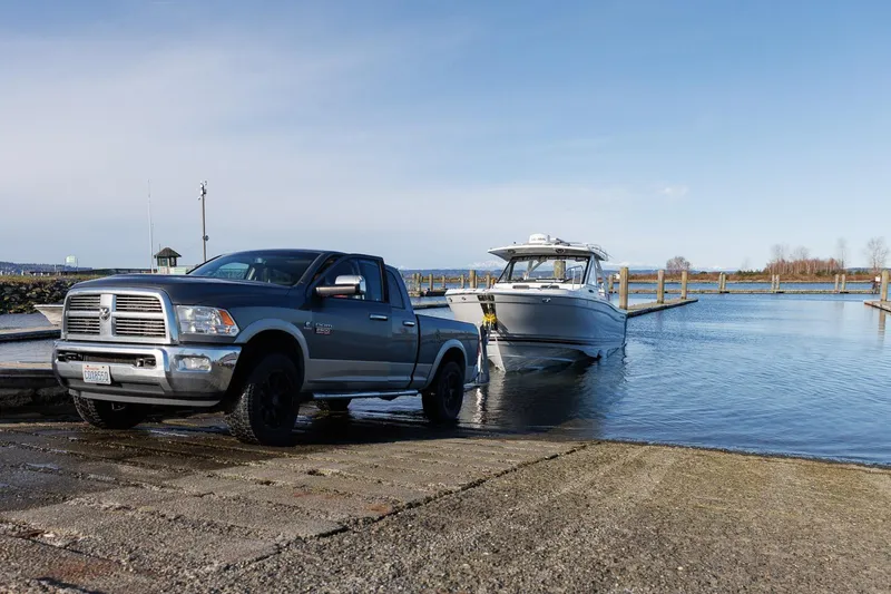 Slide: The Image of Truck launching Solara S-310 CW boat at a boat ramp, clear sky, 2025 model. - 38