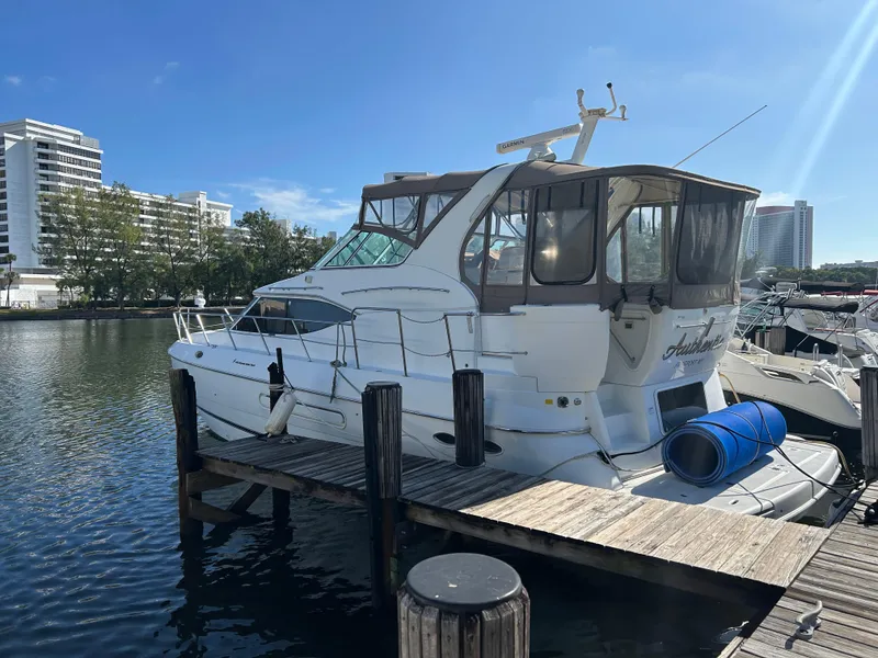Slide: The Image of 2001 Cruisers Yachts 4450 Express Motoryacht docked at marina, sunny day. - 35