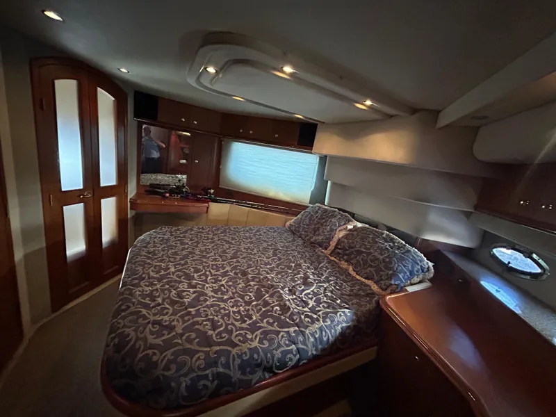 Slide: The Image of Luxurious bedroom interior of 2001 Cruisers Yachts 4450 Express Motoryacht with elegant bedding. - 46
