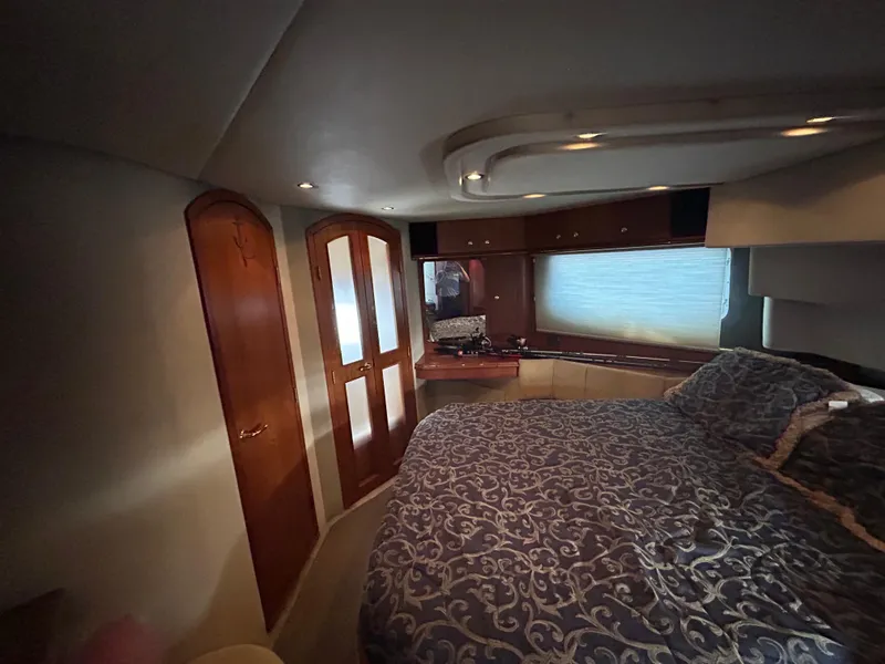 Slide: The Image of Luxurious bedroom interior of 2001 Cruisers Yachts 4450 Express Motoryacht with elegant wood finishes. - 47