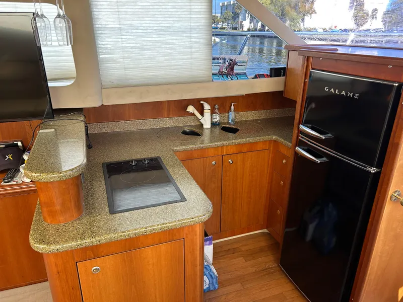 Slide: The Image of Interior of 2001 Cruisers Yachts 4450 Express Motoryacht kitchen with wood cabinetry and appliances. - 42