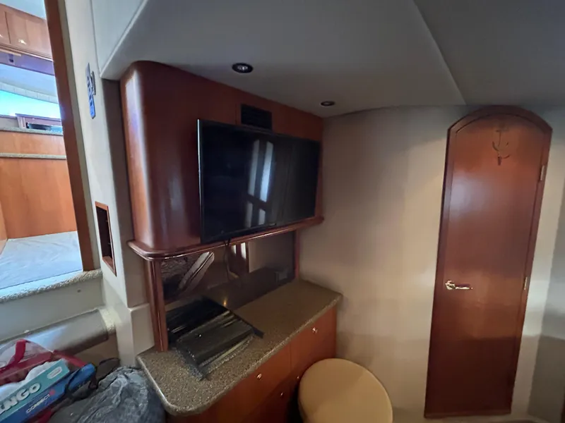 Slide: The Image of Interior of 2001 Cruisers Yachts 4450 Express Motoryacht with TV and wooden cabinetry. - 48
