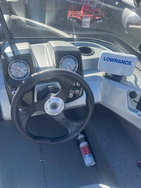 Slide: The Image of Tracker PGV16 2019 boat dashboard with steering wheel and Lowrance navigation system. - 4