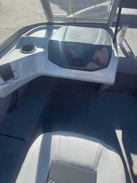 Slide: The Image of Interior of a 2019 Tracker PGV16 boat with seating and console. - 5