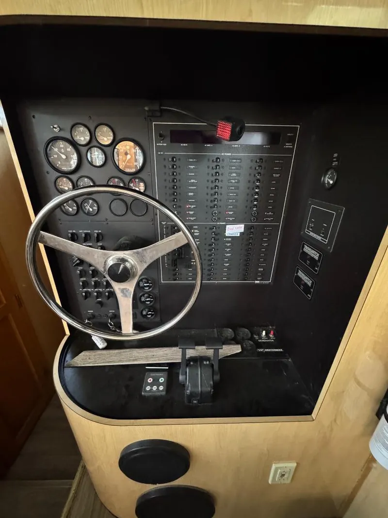 Slide: The Image of Control panel of a 2000 Bluewater Yachts 5200 Millenium with steering wheel and gauges. - 13