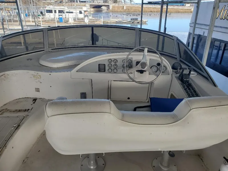 Slide: The Image of Helm of 2000 Bluewater Yachts 5200 Millennium, featuring steering wheel and control panel. - 16