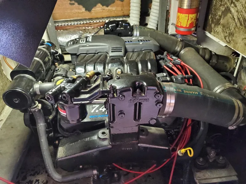 Slide: The Image of Engine compartment of a 2000 Bluewater Yachts 5200 Millenium, showcasing mechanical components and wiring. - 18