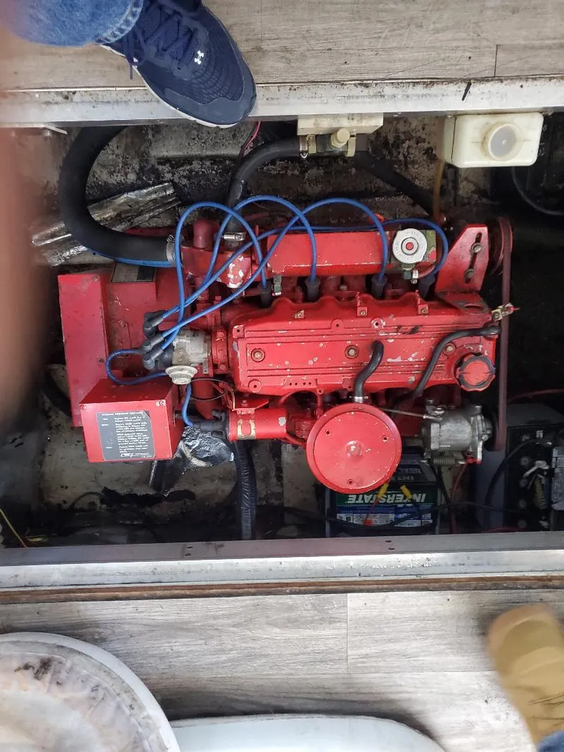 Slide: The Image of Engine compartment of a 2000 Bluewater Yachts 5200 Millenium, featuring a red engine. - 21