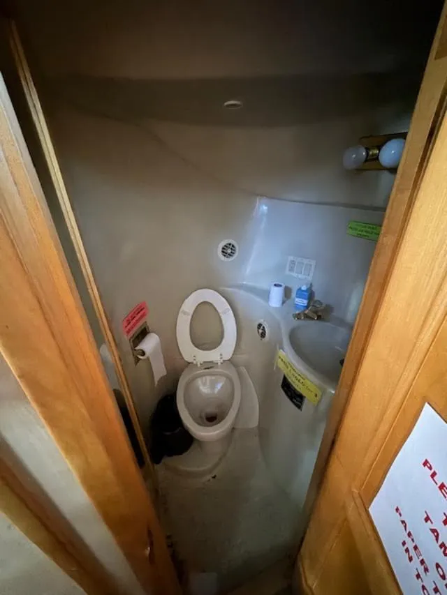 Slide: The Image of Bathroom inside 2000 Bluewater Yachts 5200 Millenium, featuring toilet and sink. - 27