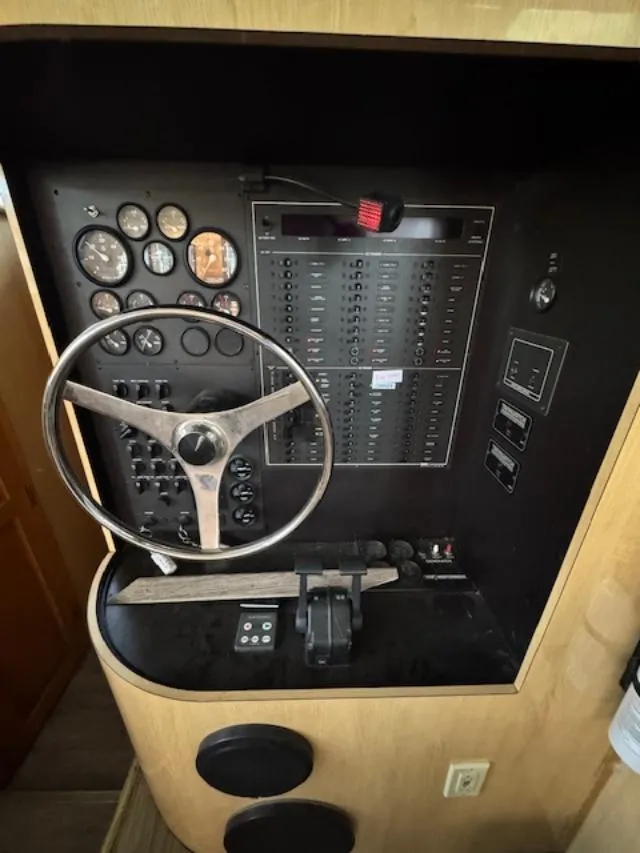 Slide: The Image of Control panel of 2000 Bluewater Yachts 5200 Millennium with steering wheel and gauges. - 29