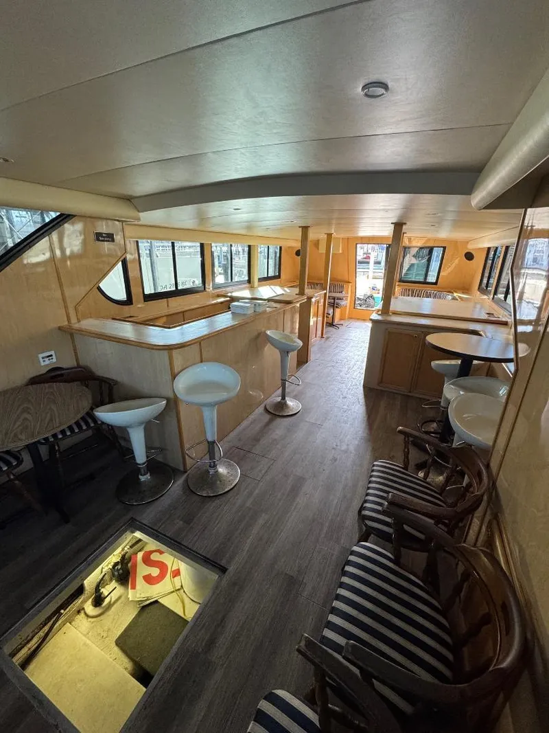 Slide: The Image of Interior of 2000 Bluewater Yachts 5200 Millenium with modern seating and wood finishes. - 9