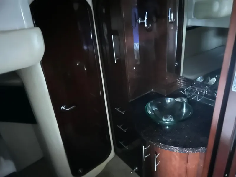 Slide: The Image of Luxurious interior of 2014 Regal 44 Sport Coupe with modern glass sink and dark wood cabinetry. - 10