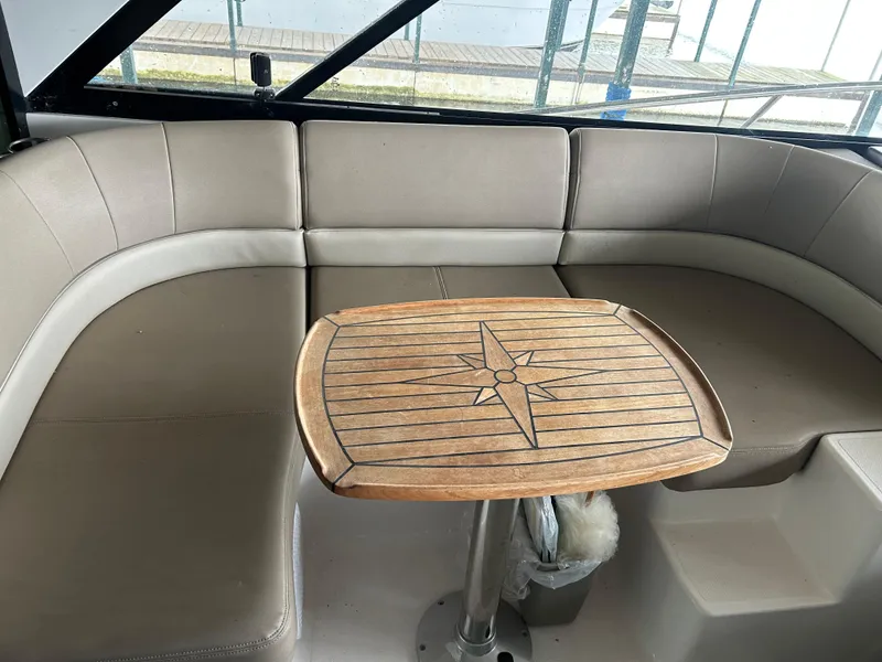 Slide: The Image of 2014 Regal 44 Sport Coupe interior with beige seating and wooden table. - 16