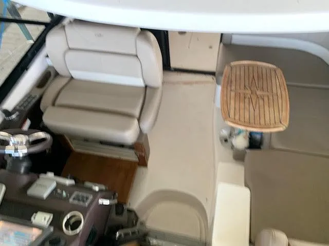 Slide: The Image of Interior of 2014 Regal 44 Sport Coupe with beige seating and wooden table. - 18