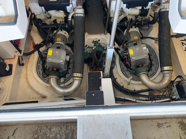 Slide: The Image of Engine compartment of a 2014 Regal 44 Sport Coupe with visible machinery and components. - 20