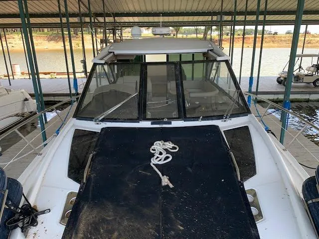 Slide: The Image of 2014 Regal 44 Sport Coupe docked under a covered marina. - 21