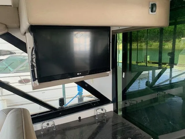 Slide: The Image of Interior of 2014 Regal 44 Sport Coupe with mounted LG TV and scenic window view. - 25