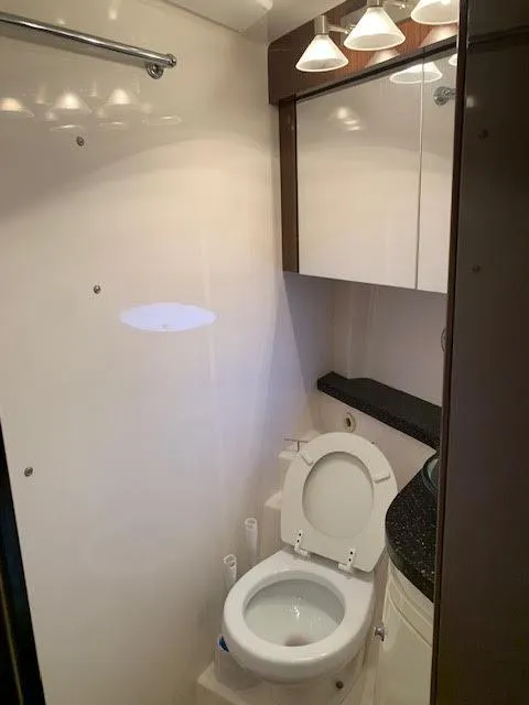 Slide: The Image of Bathroom interior of 2014 Regal 44 Sport Coupe yacht, featuring modern fixtures and lighting. - 28