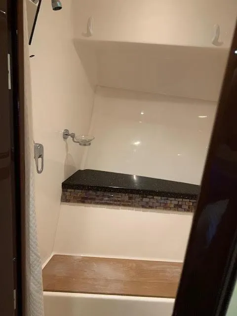 Slide: The Image of Interior shower of 2014 Regal 44 Sport Coupe with modern fixtures and seating. - 29