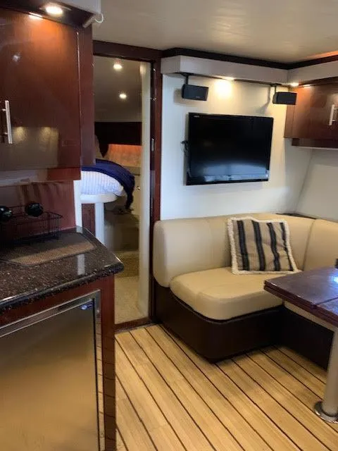 Slide: The Image of Interior of 2014 Regal 44 Sport Coupe with cozy seating and modern amenities. - 34