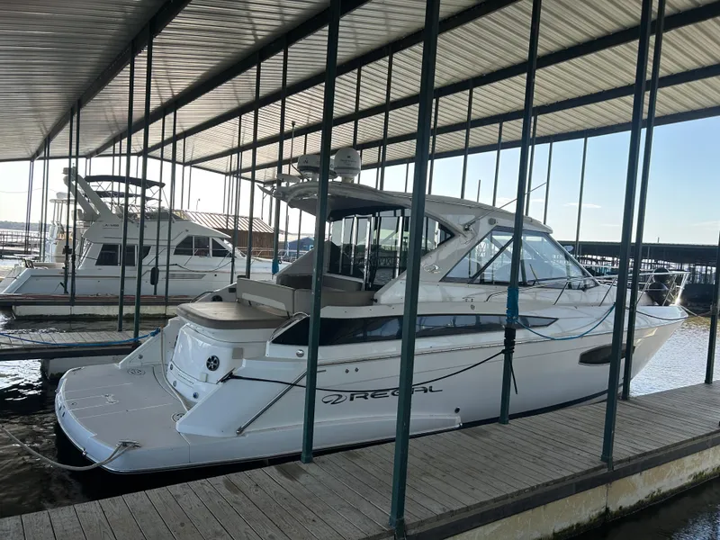 Slide: The Image of 2014 Regal 44 Sport Coupe yacht docked in a covered marina. - 4