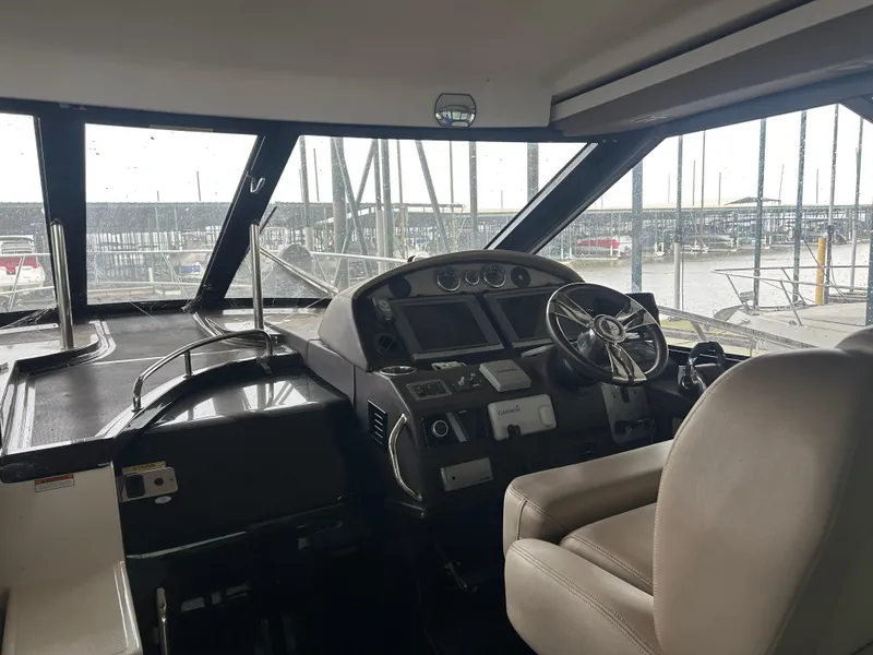 Slide: The Image of Interior cockpit of 2014 Regal 44 Sport Coupe yacht with steering wheel and controls. - 6