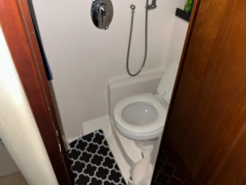 Slide: The Image of Compact bathroom in 2014 Regal 44 Sport Coupe yacht with toilet and shower. - 8