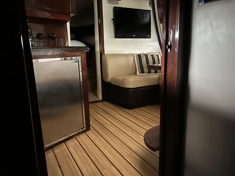 Slide: The Image of Interior of 2014 Regal 44 Sport Coupe with wood flooring and cozy seating area. - 9