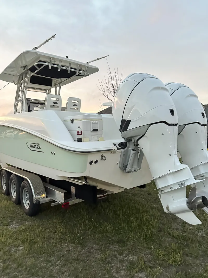 Slide: The Image of 2004 Boston Whaler 32 Outrage boat with dual engines on a trailer. - 12
