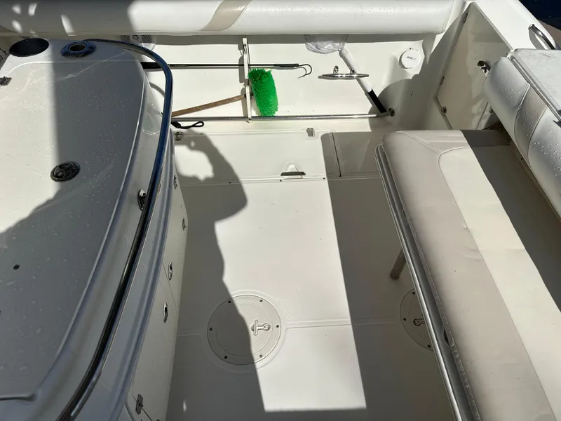 Slide: The Image of 2004 Boston Whaler 32 Outrage boat interior with seating and storage area. - 18