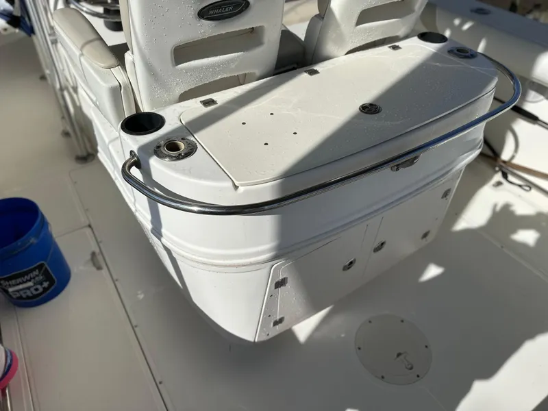 Slide: The Image of 2004 Boston Whaler 32 Outrage boat interior, featuring seating and storage compartments. - 19