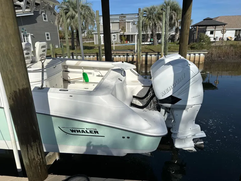 Slide: The Image of 2004 Boston Whaler 32 Outrage boat docked with Mercury outboard engine. - 2