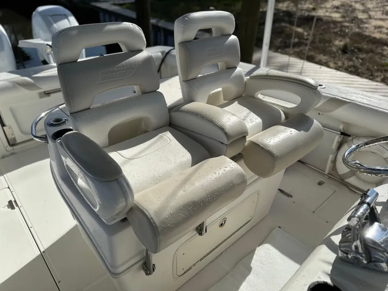 Slide: The Image of 2004 Boston Whaler 32 Outrage boat seats, white leather, dual helm chairs. - 21