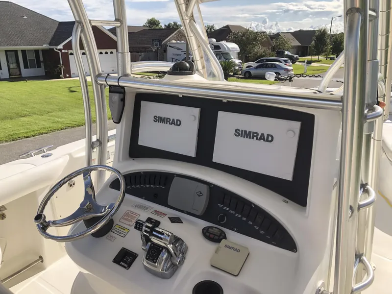 Slide: The Image of 2004 Boston Whaler 32 Outrage helm with dual Simrad displays and steering wheel. - 23
