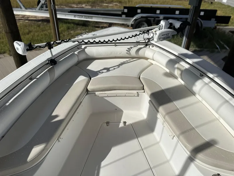 Slide: The Image of 2004 Boston Whaler 32 Outrage boat interior with cushioned seating and anchor setup. - 28