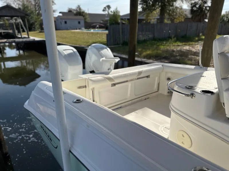 Slide: The Image of 2004 Boston Whaler 32 Outrage boat docked, featuring dual outboard engines. - 3