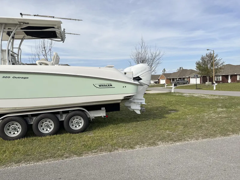 Slide: The Image of 2004 Boston Whaler 32 Outrage boat on trailer in suburban neighborhood. - 8