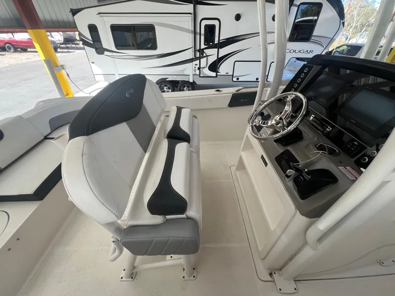 Slide: The Image of 2019 Robalo R242 Explorer boat interior with helm and seating. - 10